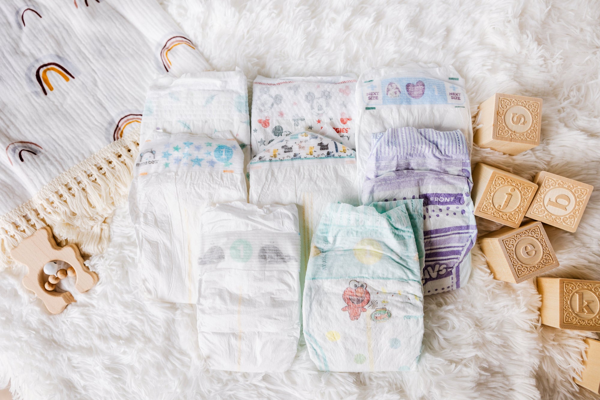 Modest Mama Diaper Sampler Package: 9 Diaper Sample Packs of cost-effective diapers including Kirkland Signature, Mama Bear, Member's Mark, Up & Up, Parent's Choice, Huggies Snug & Dry, Pampers Baby Dry and Luvs